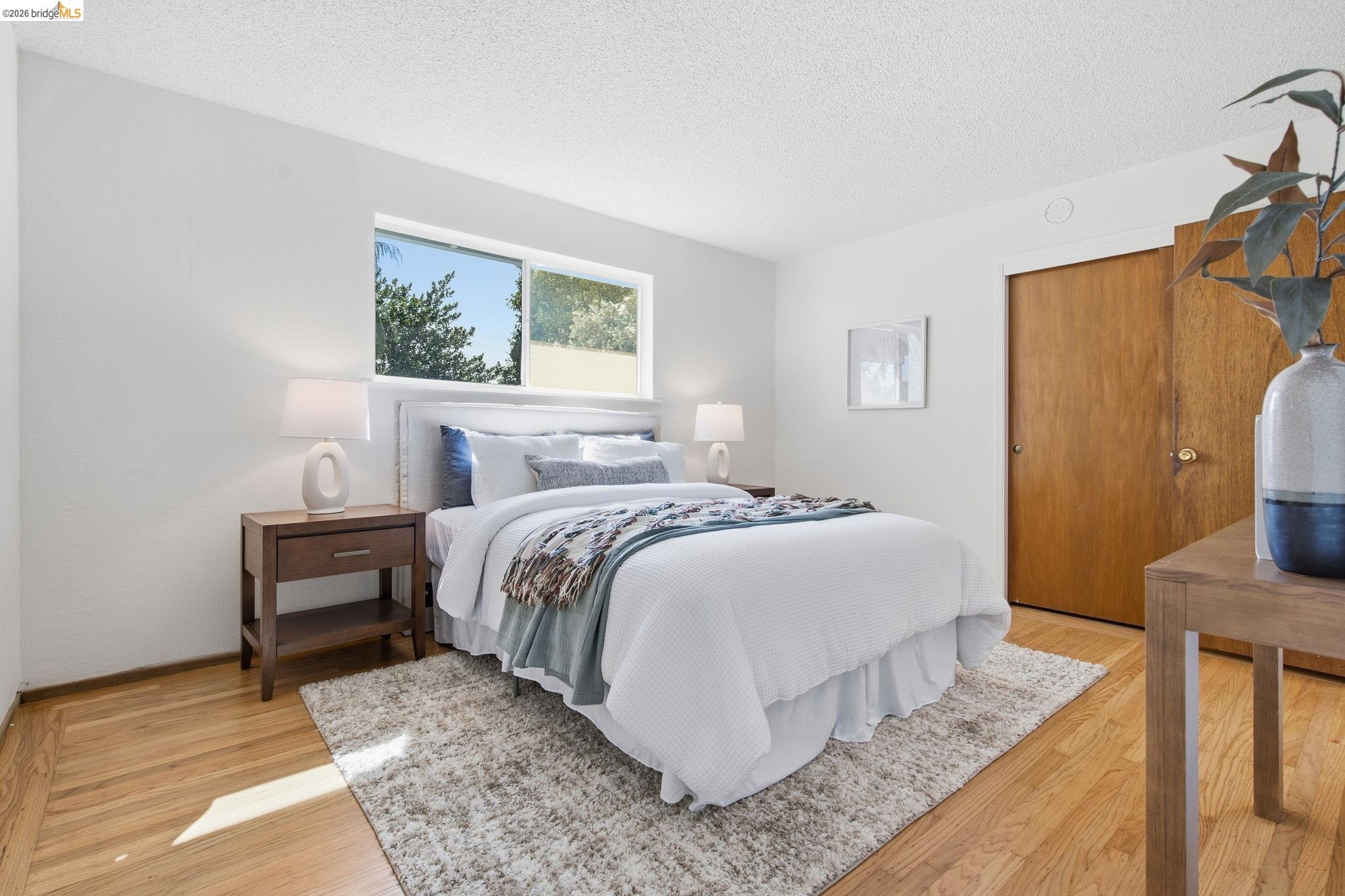 4522 Santa Rita Road El Sobrante, CA 94803 - Photo 24 of 58 Hardwood flooring, white walls, and a window providing natural illumination