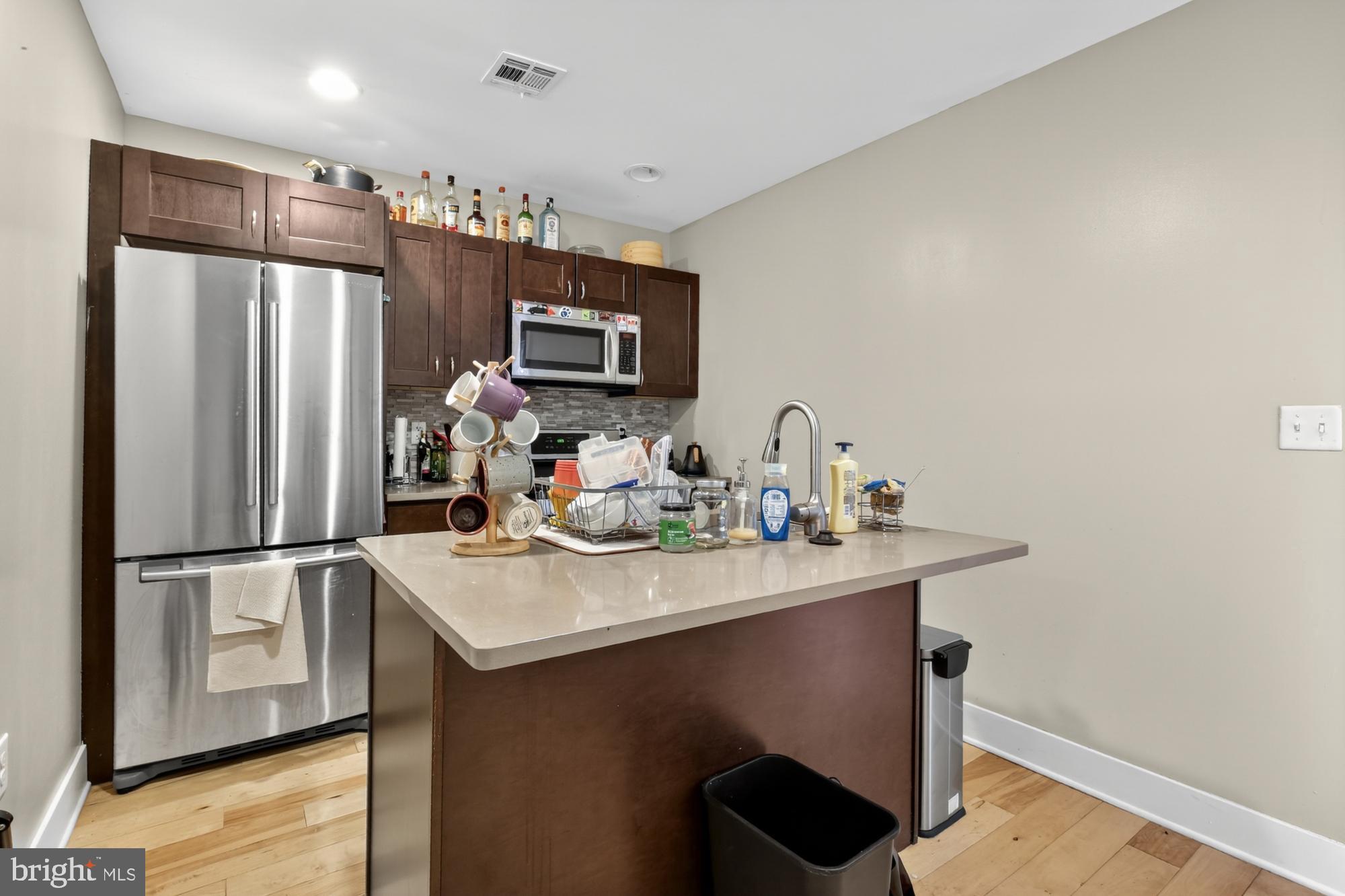 709 North 3rd Street, Unit 3 Philadelphia, PA 19123 - Photo 7 of 17 a kitchen with kitchen island a sink appliances and cabinets