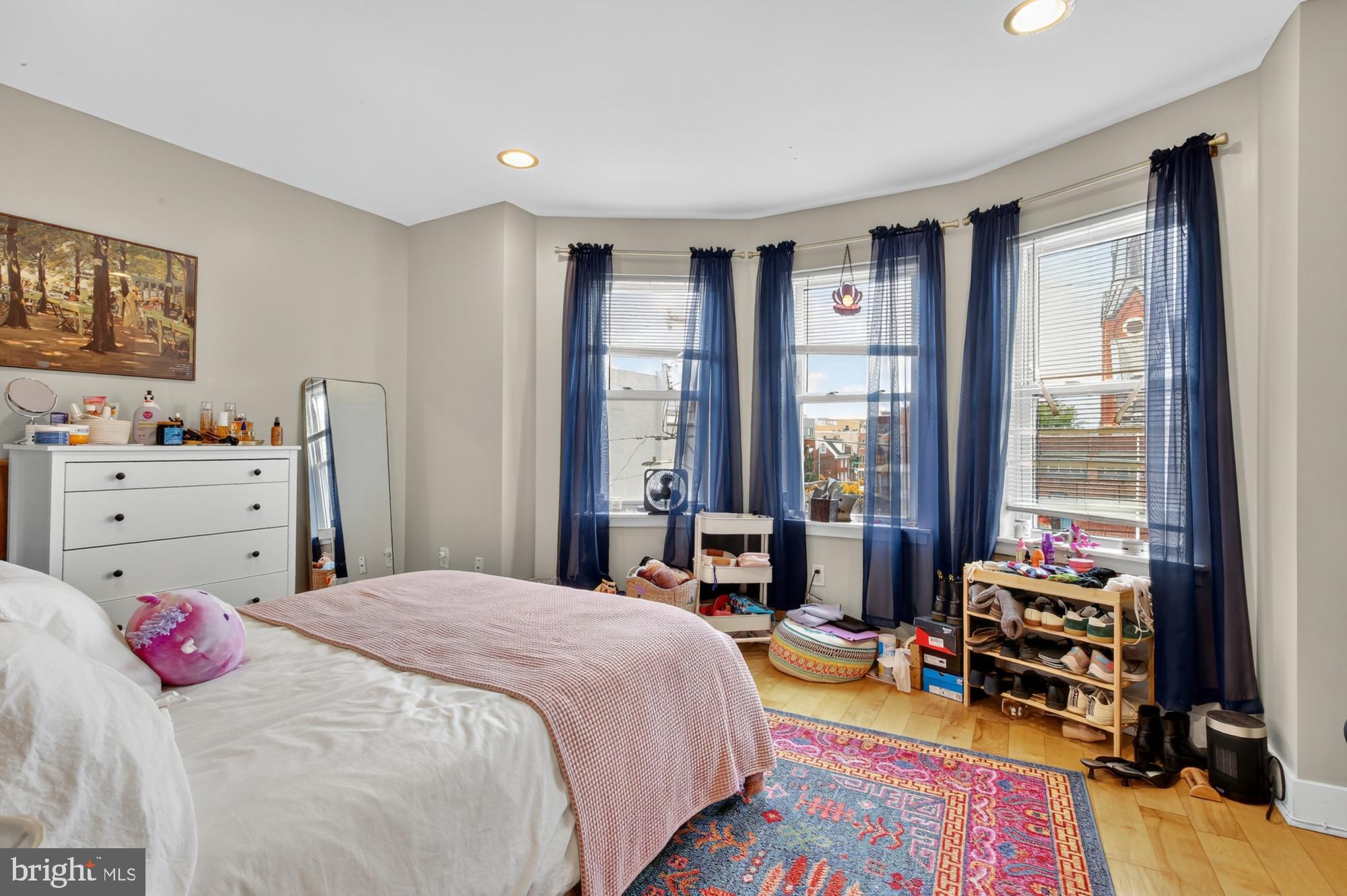 709 North 3rd Street, Unit 3 Philadelphia, PA 19123 - Photo 10 of 17 a bedroom with a bed and wooden floor