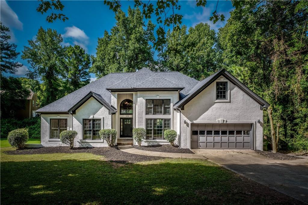 1258 Springhouse Lane Southwest Atlanta, GA 30311 - Photo 1 of 1 a front view of a house with a garden and porch