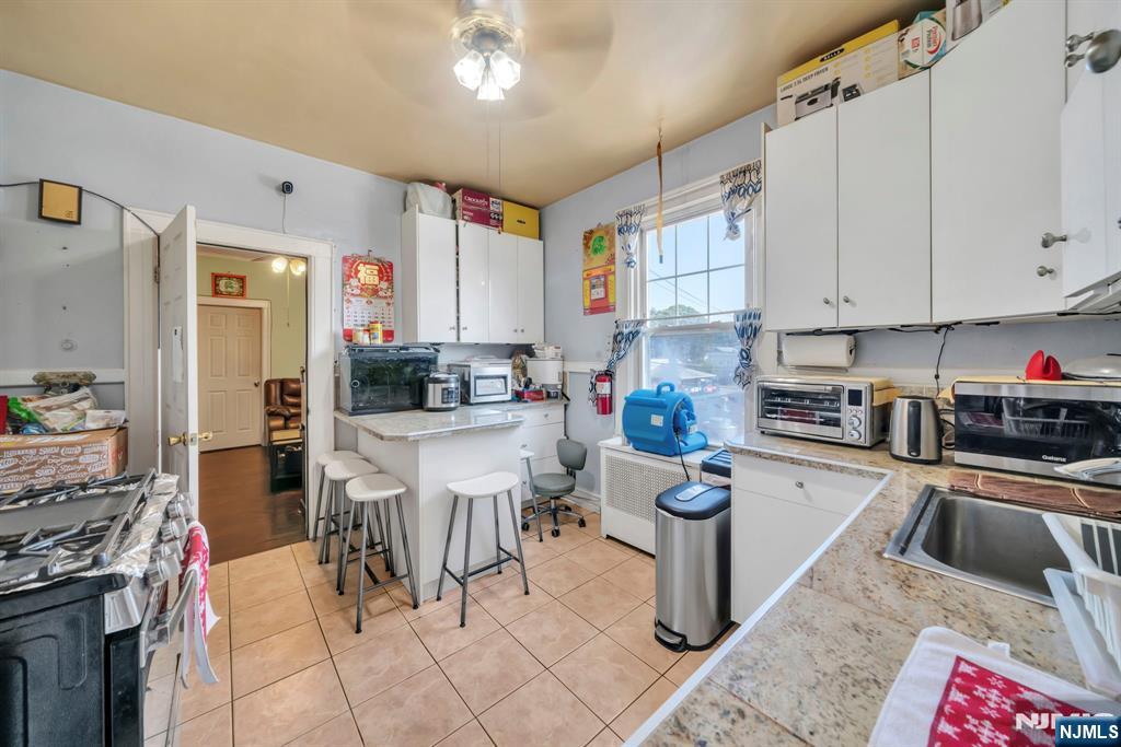 688 Passaic Avenue Nutley, NJ 07110 - Photo 14 of 42 a kitchen with stainless steel appliances kitchen island granite countertop a sink and cabinets