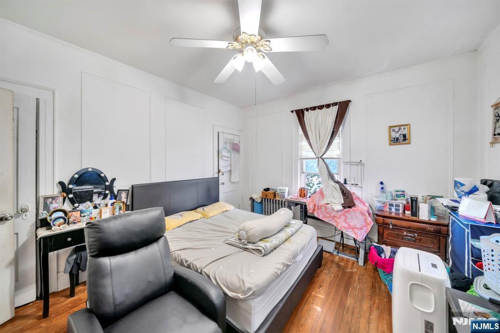 688 Passaic Avenue Nutley, NJ 07110 - Photo 25 of 42 a bedroom with furniture and a chandelier