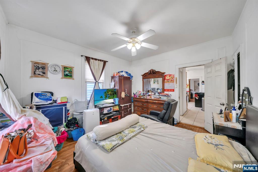 688 Passaic Avenue Nutley, NJ 07110 - Photo 27 of 42 a bedroom with a bed and wooden floor