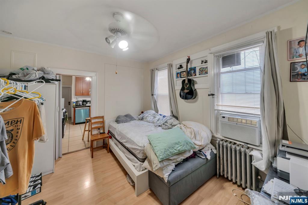 688 Passaic Avenue Nutley, NJ 07110 - Photo 35 of 42 a bedroom with a bed and a flat tv screen on the dresser