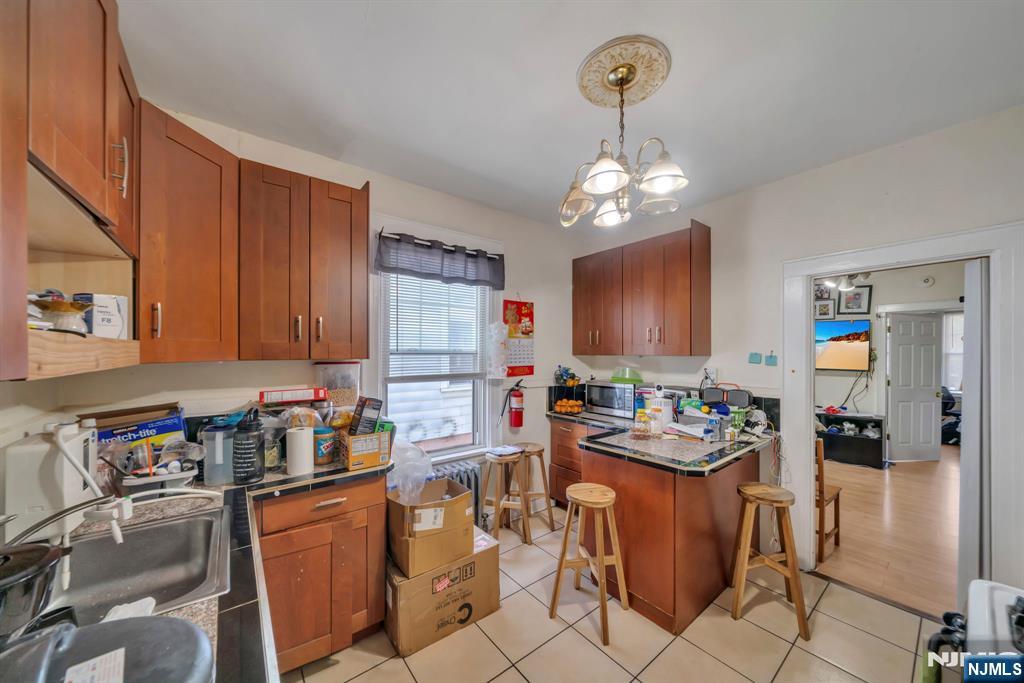 688 Passaic Avenue Nutley, NJ 07110 - Photo 37 of 42 a kitchen with a refrigerator and a stove top oven