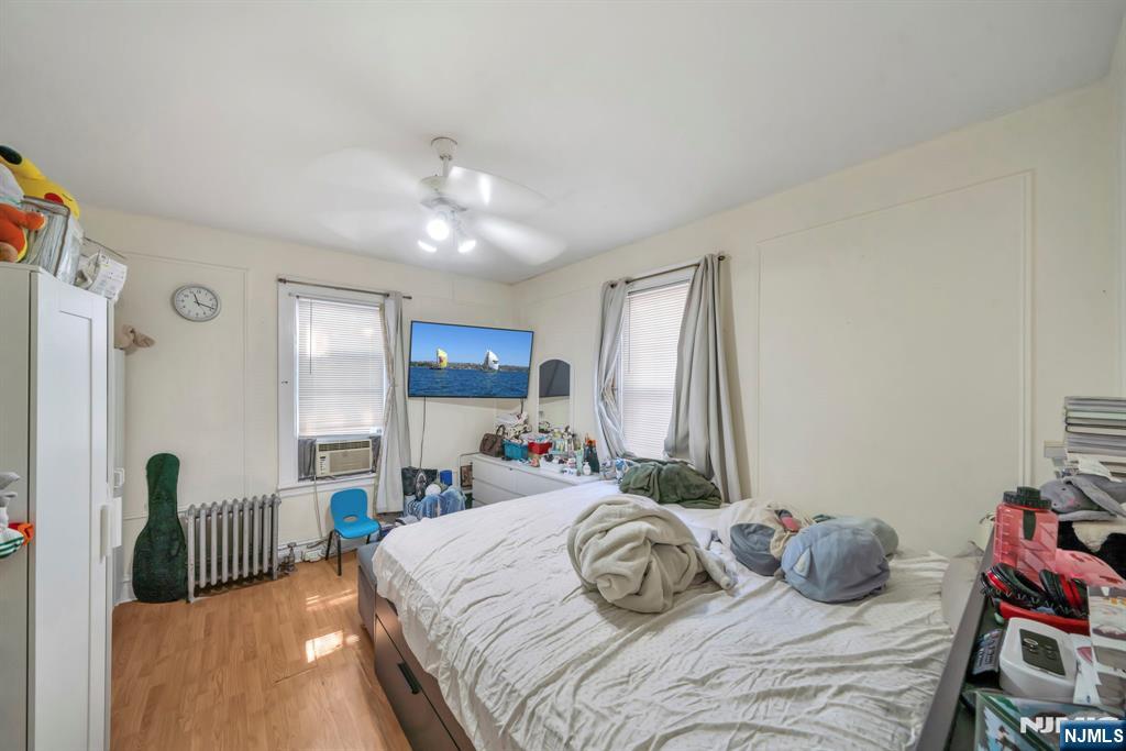 688 Passaic Avenue Nutley, NJ 07110 - Photo 39 of 42 a bedroom with a bed and a chandelier