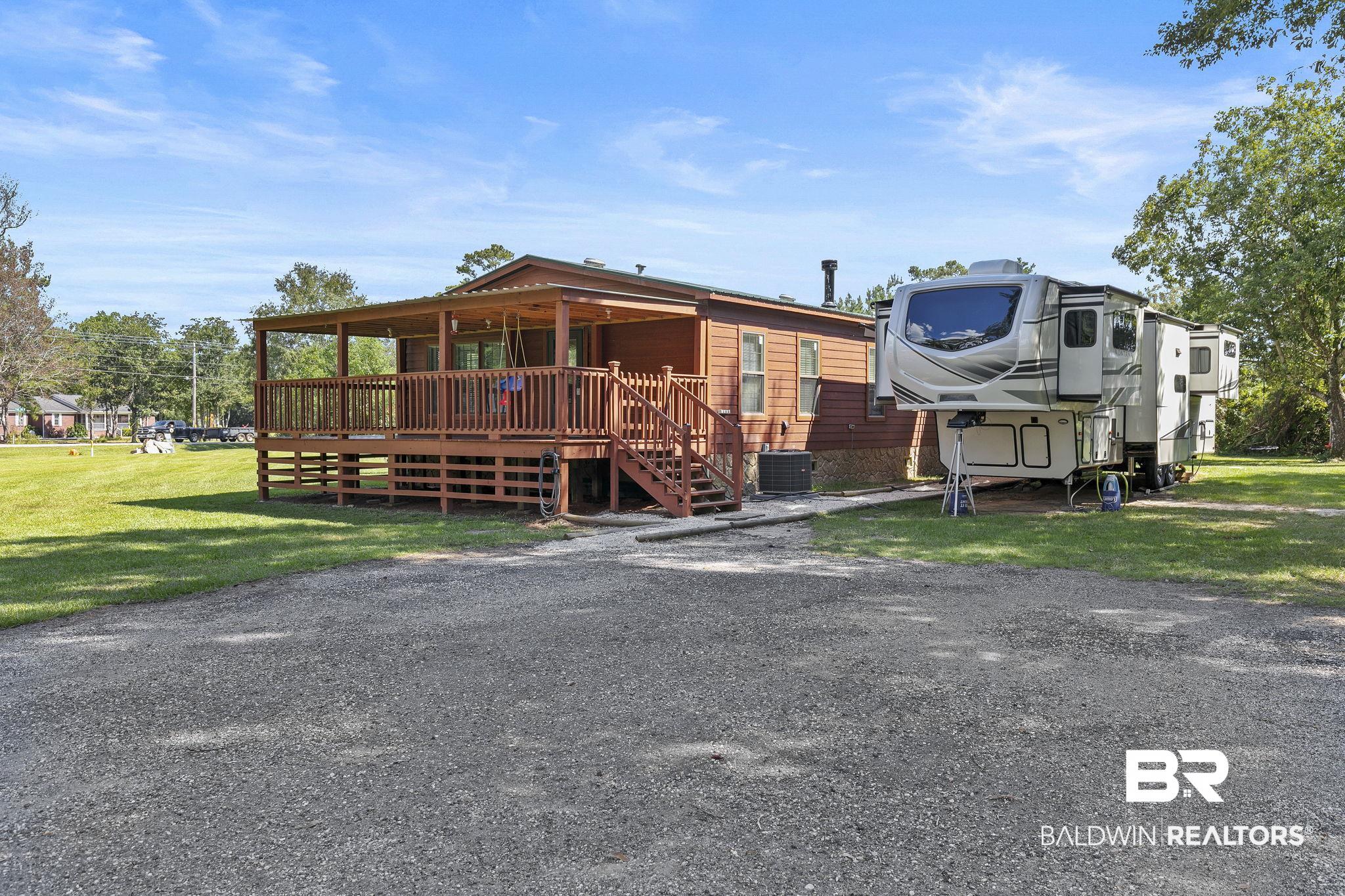 35641 County Road 39 Stapleton, AL 36578 - Photo 6 of 46 Exterior space with a deck, a lawn, and central AC