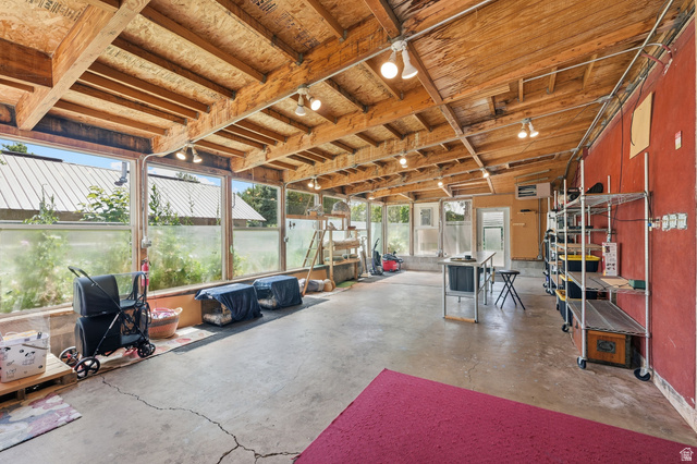 365 North Main Street Fillmore, UT 84631 - Photo 28 of 51 Spacious sunroom featuring exposed wood ceiling beams, multiple windows, concrete flooring, and track lighting