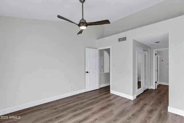 a view of a room with wooden floor