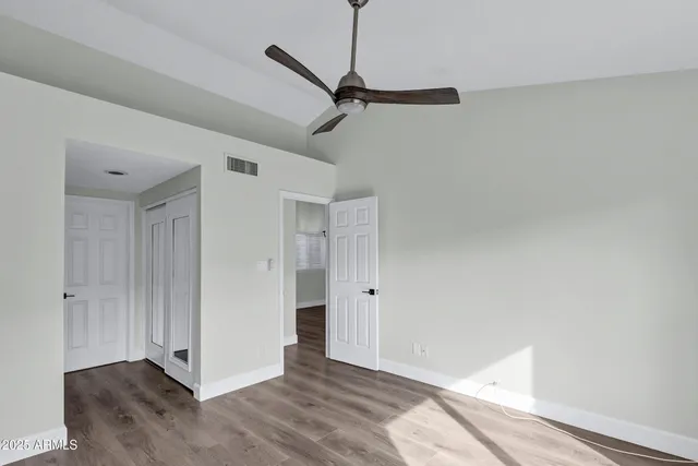 a view of a room with wooden floor