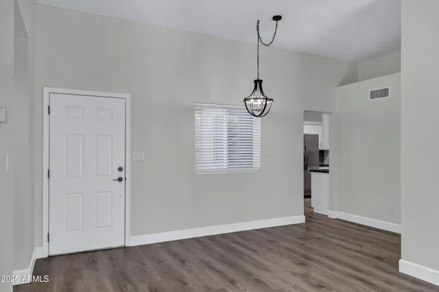 a view of a room with wooden floor closet and windows