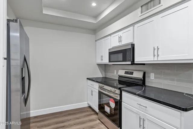 a kitchen with stainless steel appliances a microwave and a refrigerator