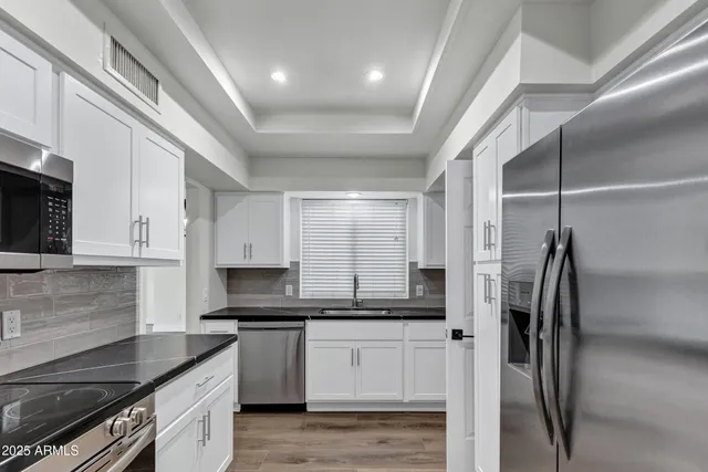 a kitchen with a refrigerator and a sink