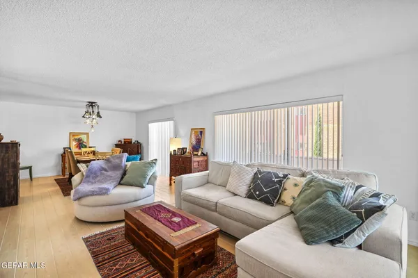 a kitchen with stainless steel appliances kitchen island granite countertop a stove a sink and a wooden floors