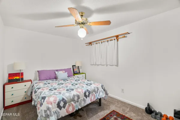 a bedroom with a bed chandelier and window