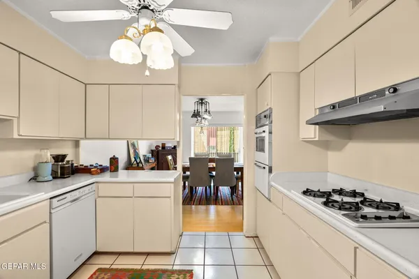 a kitchen with cabinets appliances a sink and a counter top space
