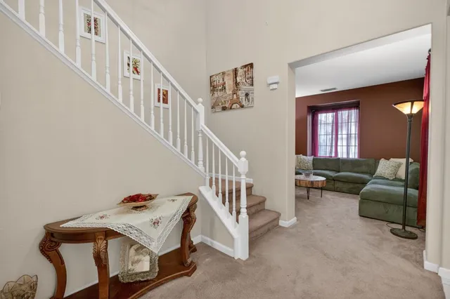 a view of a livingroom with furniture and stairs
