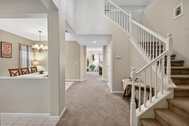 a living room with furniture kitchen view and a large window
