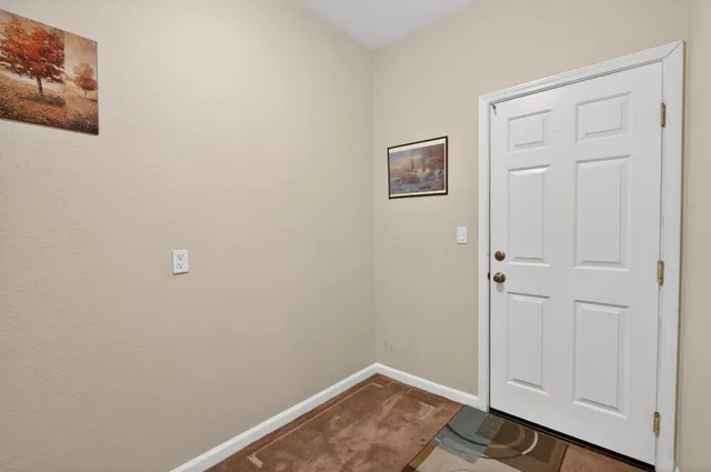 a kitchen with stainless steel appliances granite countertop a sink a stove a dining table and chairs