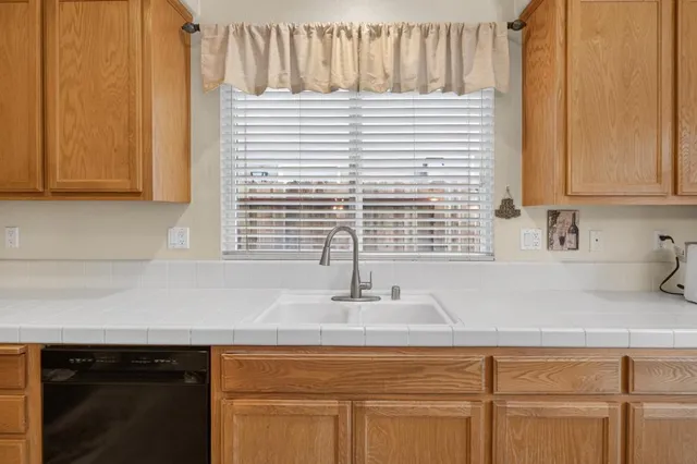 a living room with furniture and two window