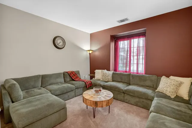 a view of a dining room with furniture and a chandelier