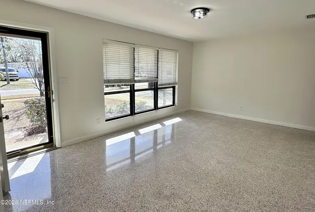 a kitchen with stainless steel appliances granite countertop a stove top oven a sink dishwasher a dining table and chairs with wooden floor