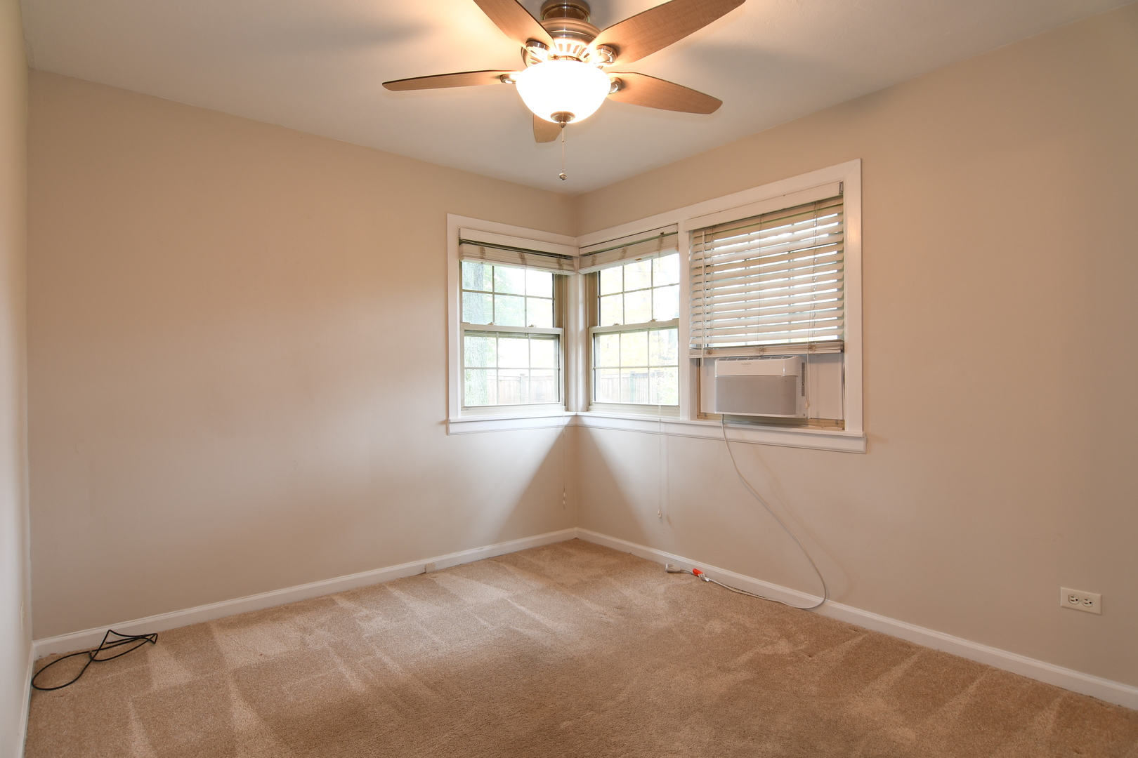909 Warrenville Road Wheaton, IL 60189 - Photo 11 of 22 an empty room with a window and a ceiling fan
