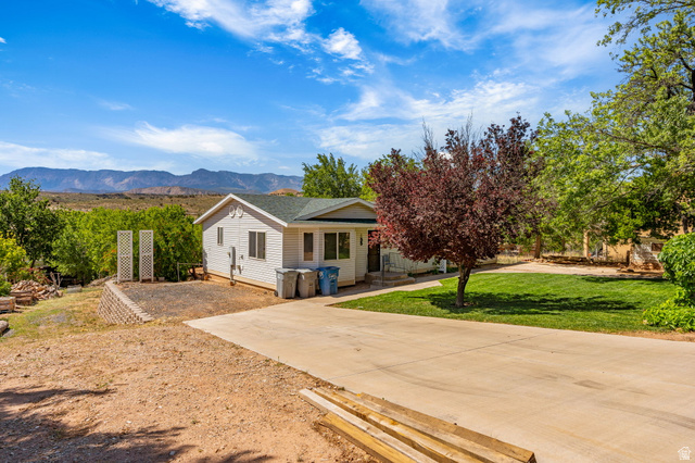 55 Spring Drive Toquerville, UT 84774 - Photo 3 of 36 View of front of home with a front lawn and a mountain view