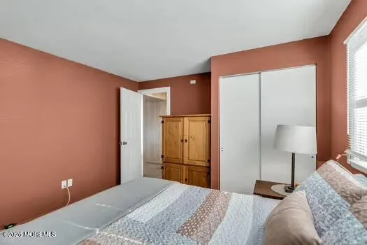 a bedroom with a bed and a lamp