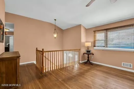 a view of a room with wooden floor and a window