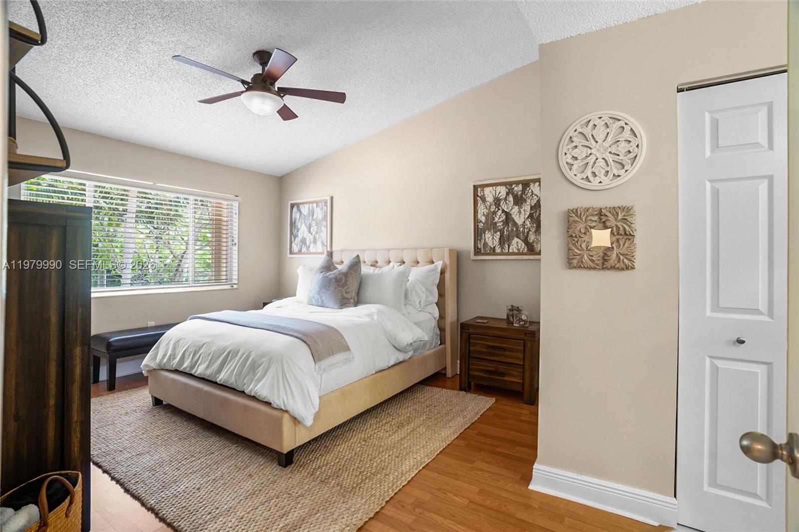 10978 Southwest 75th Terrace Miami, FL 33173 - Photo 12 of 34 a bedroom with a large bed and a chandelier