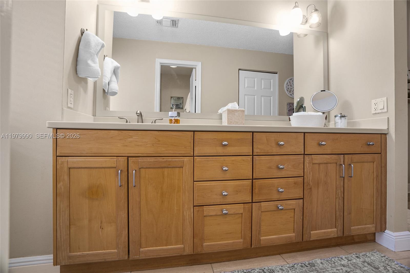 10978 Southwest 75th Terrace Miami, FL 33173 - Photo 13 of 34 a bathroom with a sink mirror and cabinets
