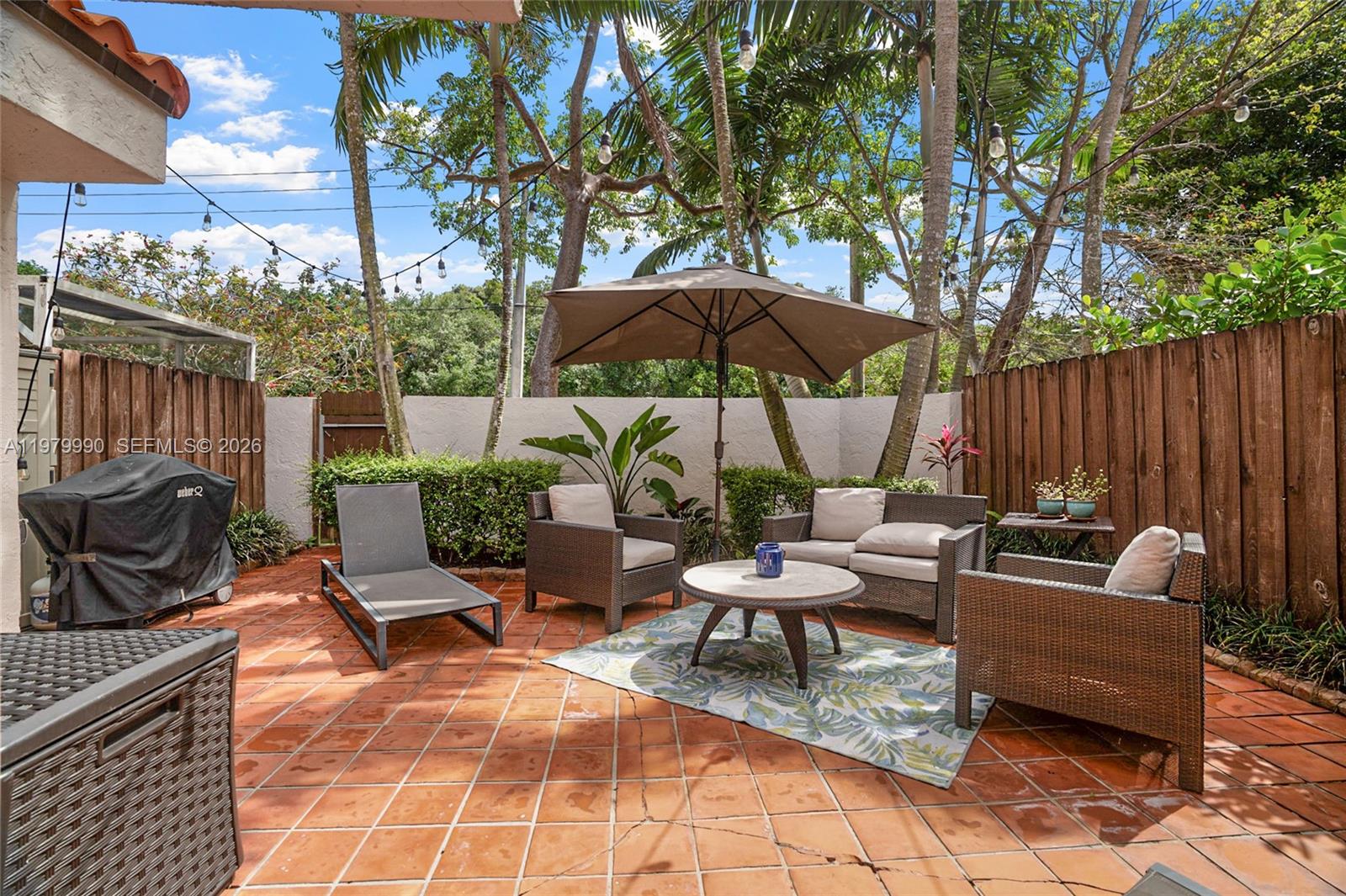 10978 Southwest 75th Terrace Miami, FL 33173 - Photo 18 of 34 a view of a chairs and table in the back yard of the house