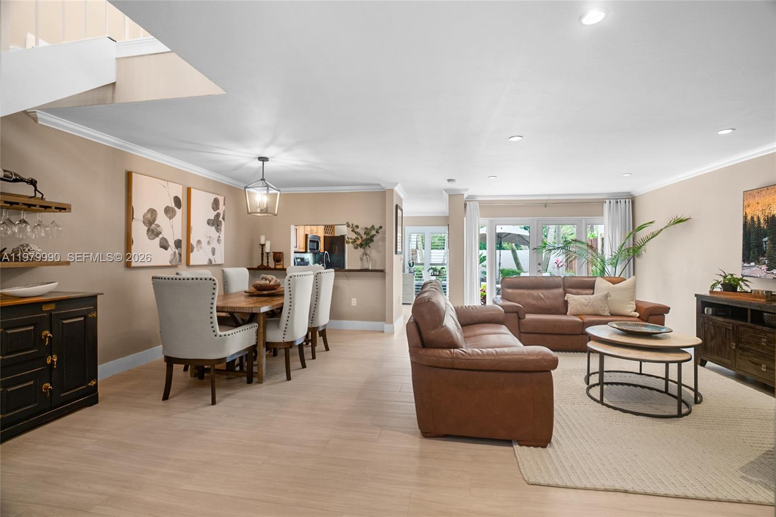 10978 Southwest 75th Terrace Miami, FL 33173 - Photo 3 of 34 a living room with furniture and a dining table with kitchen appliances