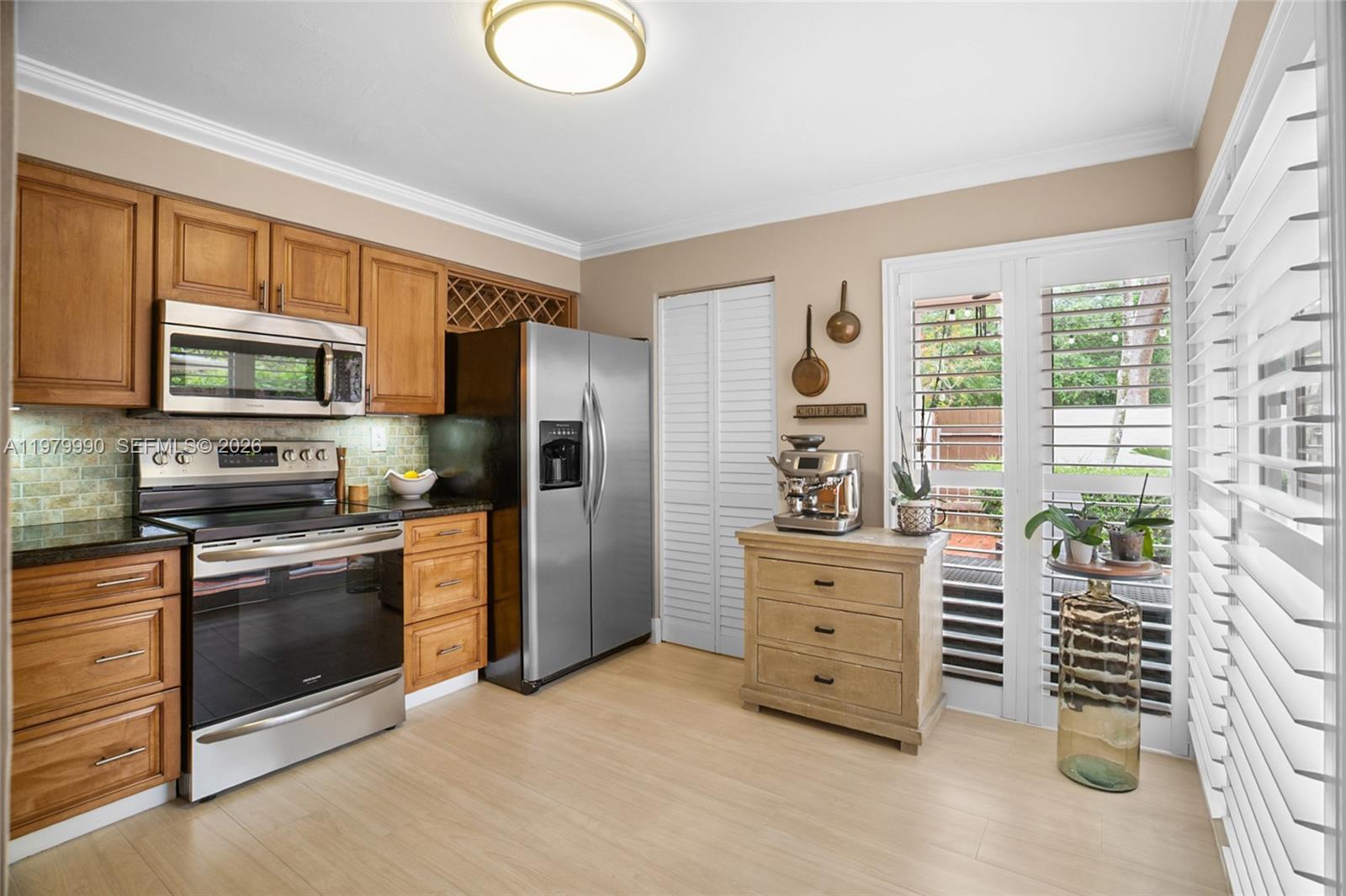 10978 Southwest 75th Terrace Miami, FL 33173 - Photo 6 of 34 a kitchen with stainless steel appliances a stove cabinets and a refrigerator