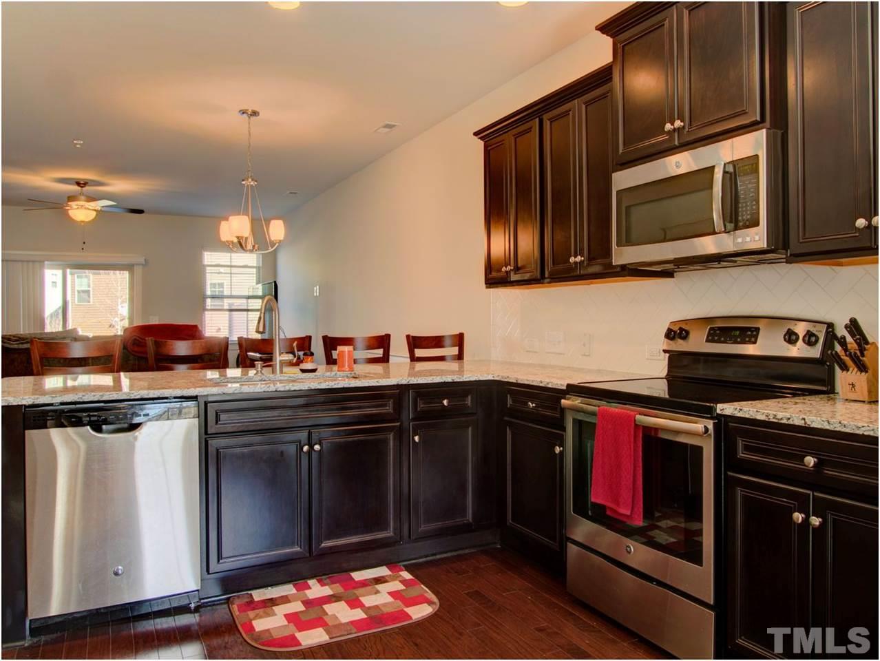 7902 Allscott Way Raleigh, NC 27612 - Photo 1 of 25 Lots of upgrades to this townhome, check out these rich recessed panel cabinets with crown molding.