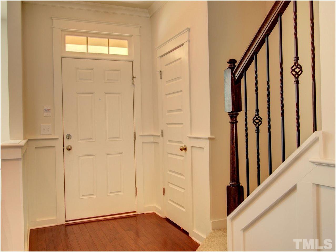 7902 Allscott Way Raleigh, NC 27612 - Photo 13 of 25 Pretty foyer with a transom above the door for light and privacy. Upgraded iron spindles on the staircase keep the open feel. There is a coat closet and half bath as well.
