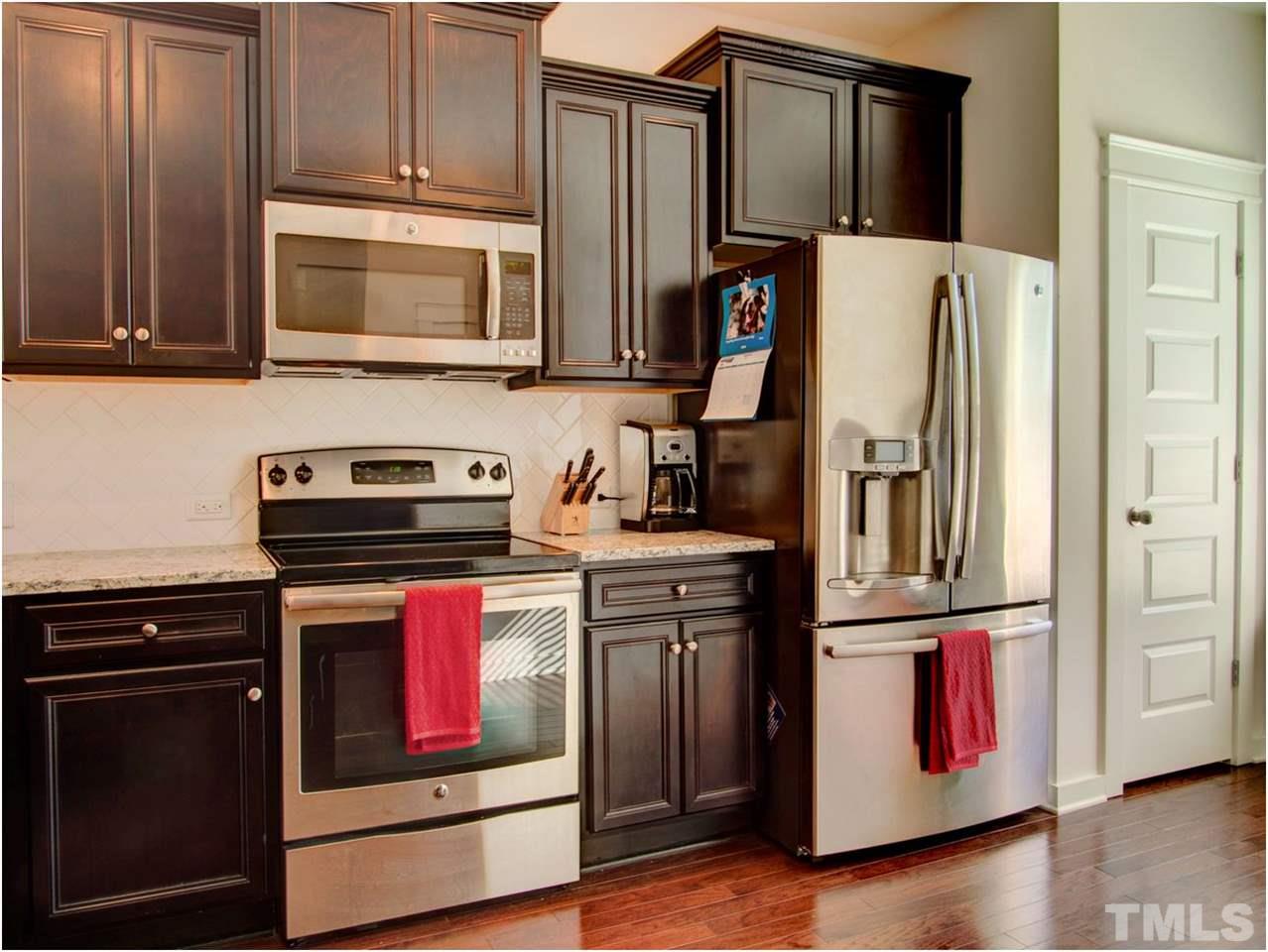 7902 Allscott Way Raleigh, NC 27612 - Photo 3 of 25 Stainless steel appliances, refrigerator included. All less than a year old! There is plenty of storage in the cabinets, but there is a pantry too!