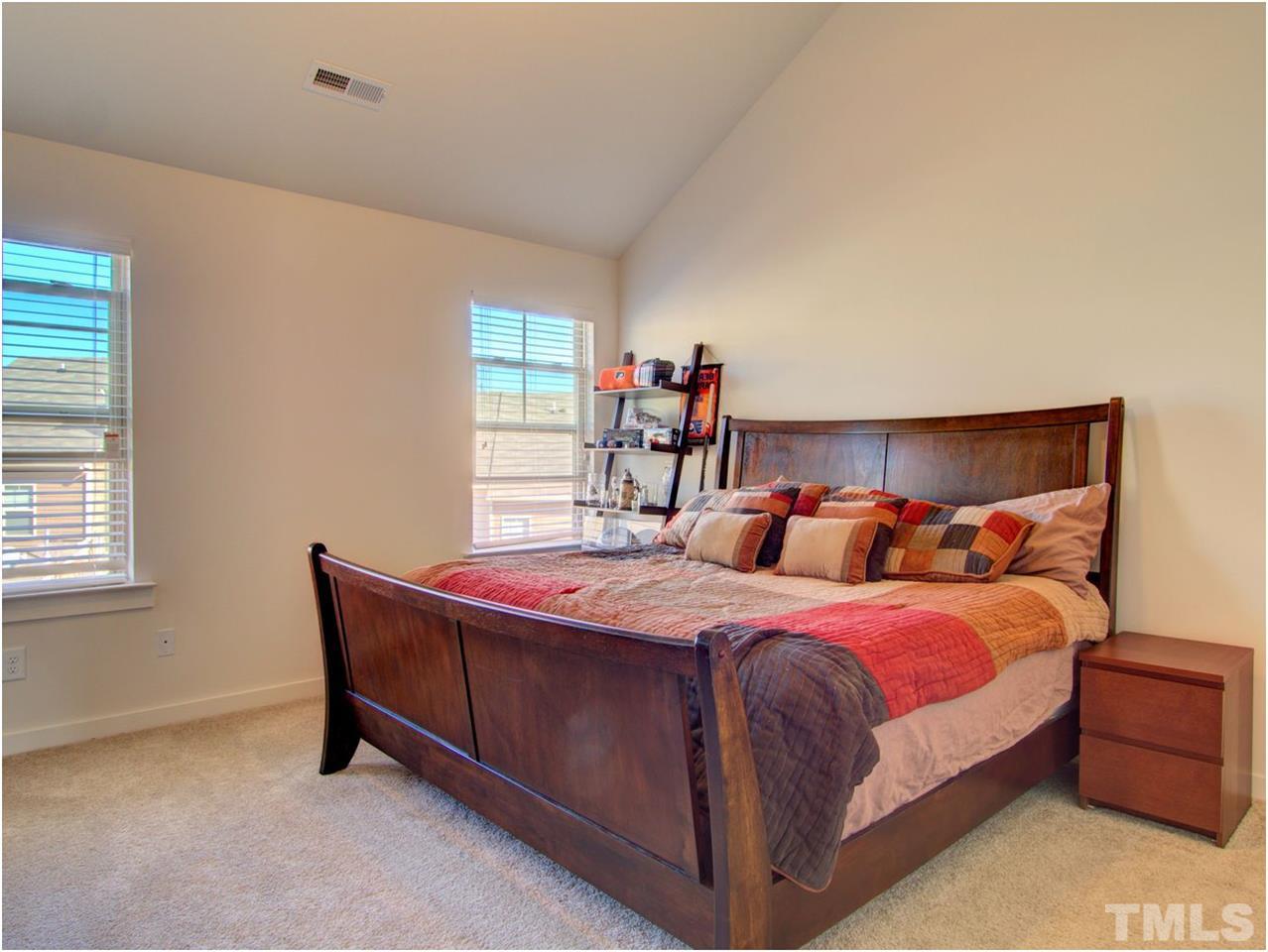 7902 Allscott Way Raleigh, NC 27612 - Photo 8 of 25 That's a king bed fitting easily with room in this master bedroom. The vaulted ceilings and ceiling fan are a plus as well.