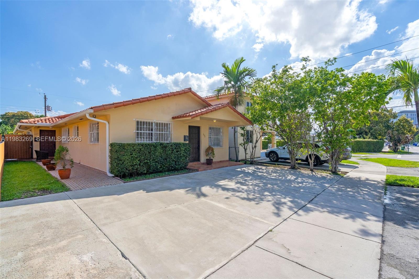 3572 Southwest 25th Street Miami, FL 33133 - Photo 2 of 18 a front view of a house with a yard and a garden