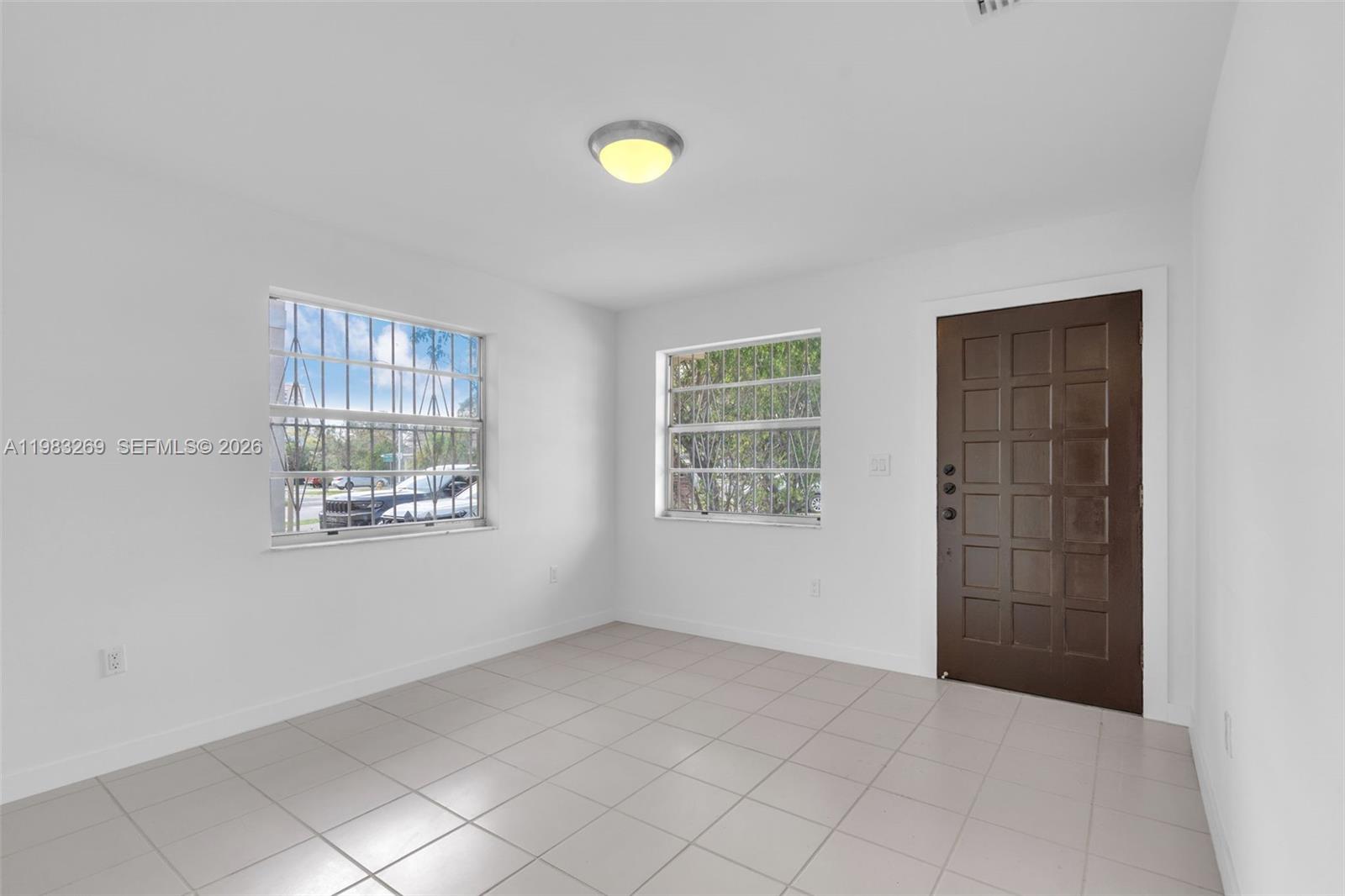3572 Southwest 25th Street Miami, FL 33133 - Photo 4 of 18 a view of an empty room with a window