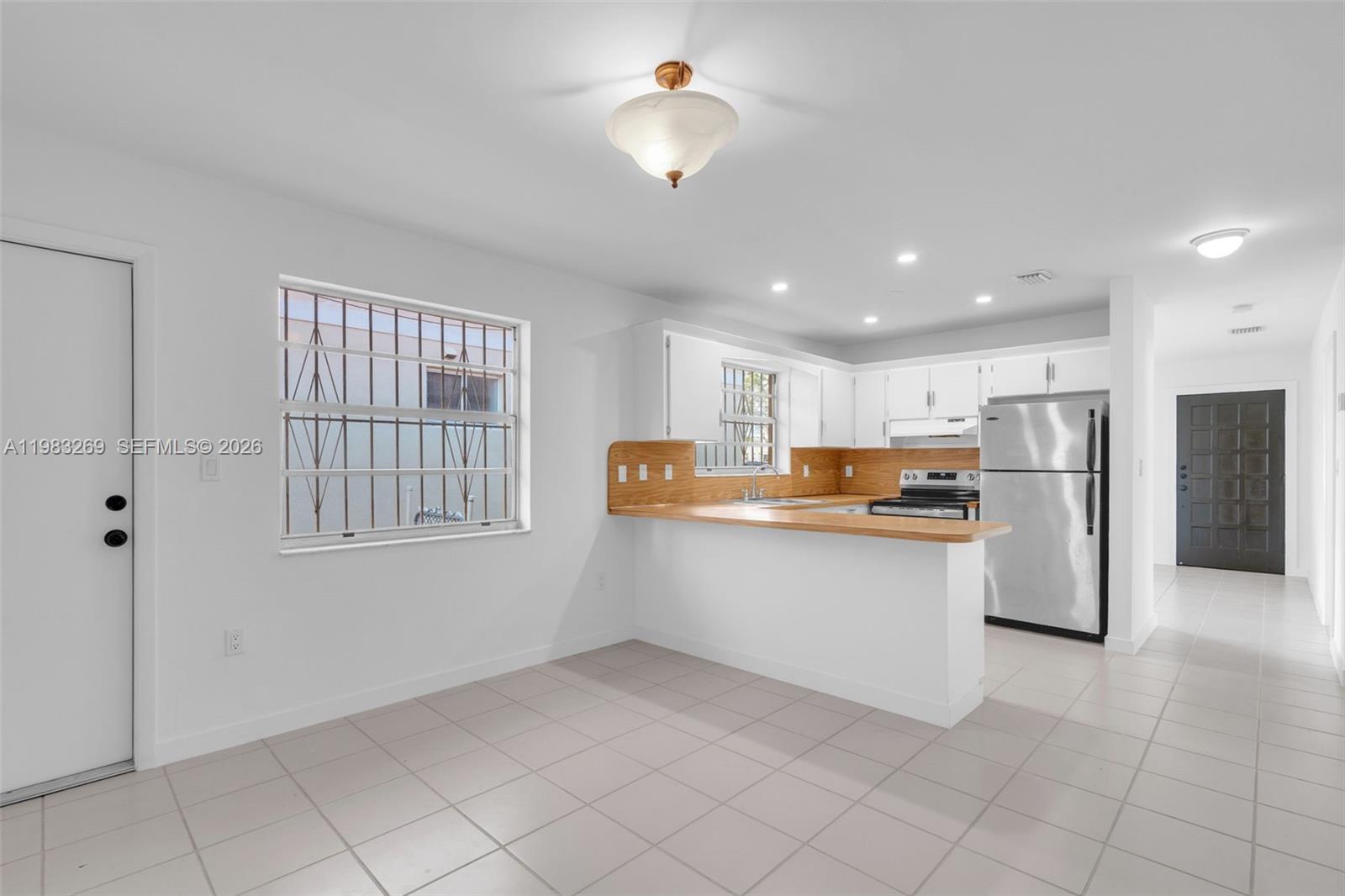 3572 Southwest 25th Street Miami, FL 33133 - Photo 7 of 18 a kitchen with refrigerator and window