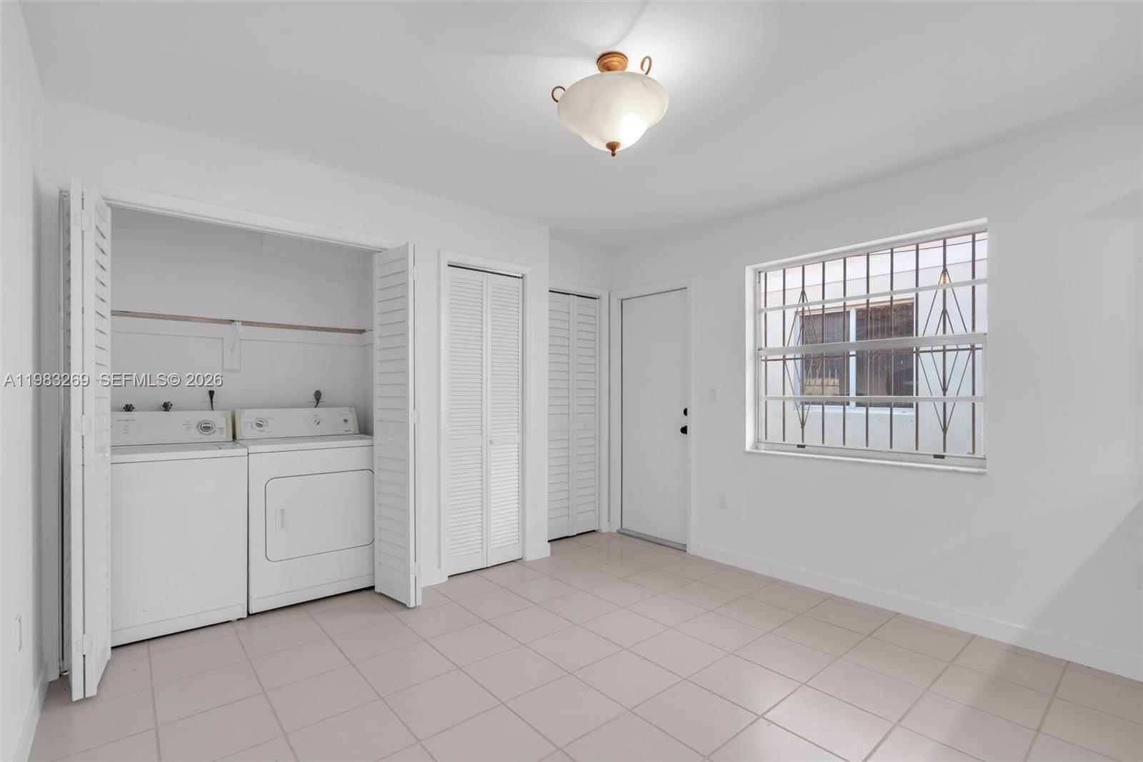 3572 Southwest 25th Street Miami, FL 33133 - Photo 8 of 18 a view of an empty room with a fan and a window