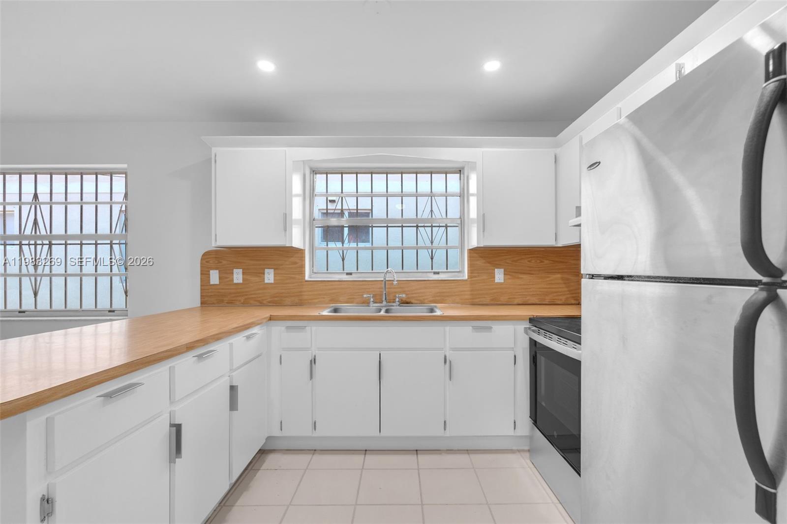 3572 Southwest 25th Street Miami, FL 33133 - Photo 9 of 18 a kitchen with a sink stove and refrigerator