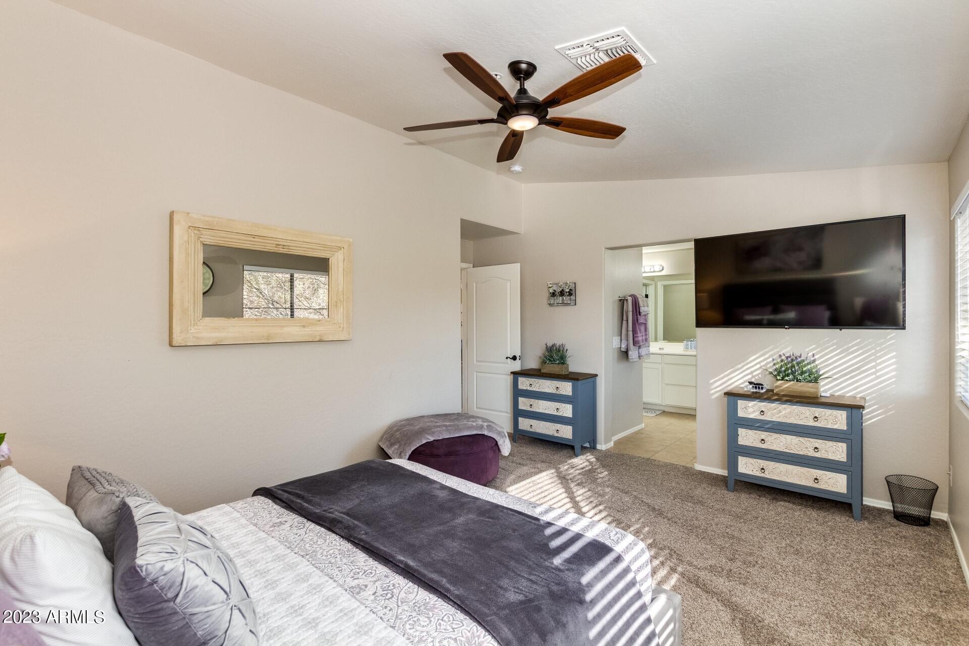 5415 East McKellips Road, Unit 94 Mesa, AZ 85215 - Photo 12 of 64 a bedroom with a bed and a flat screen tv