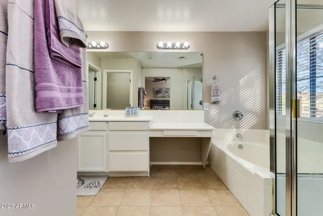 a bathroom with a bathtub sink and mirror
