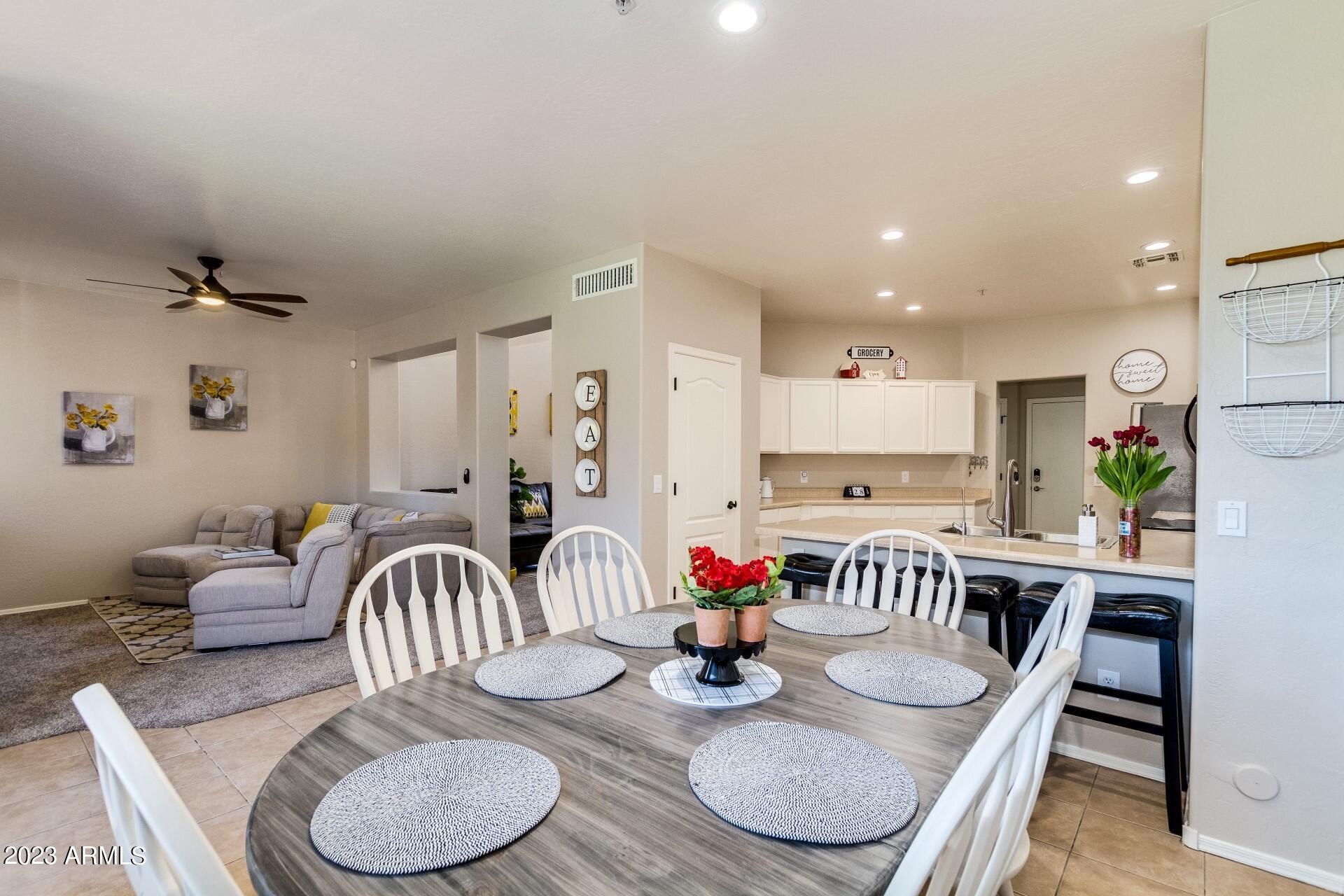 5415 East McKellips Road, Unit 94 Mesa, AZ 85215 - Photo 16 of 64 a dining room with furniture a rug and wooden floor