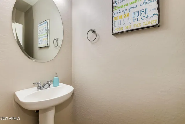 a bathroom with a sink and mirror