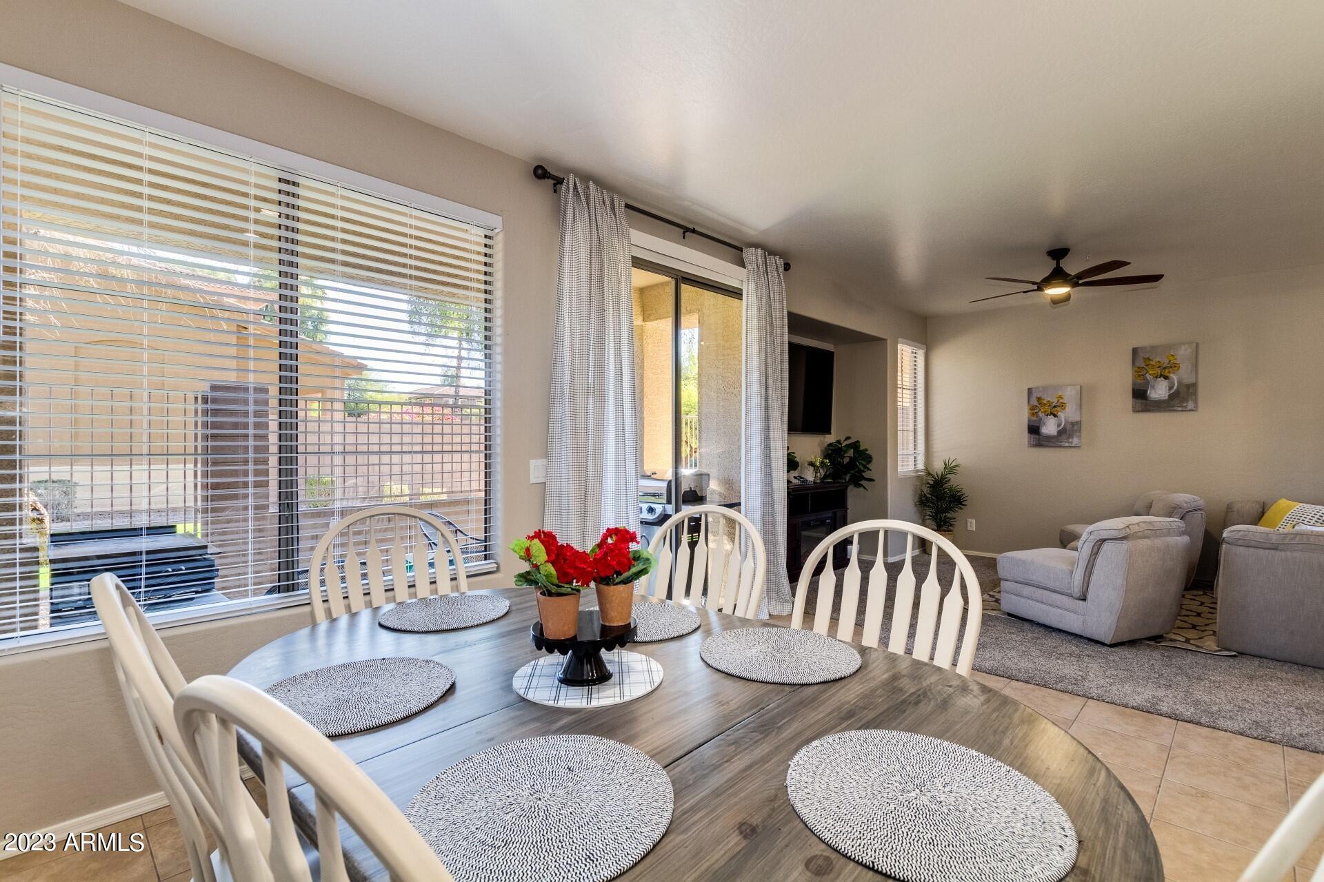 5415 East McKellips Road, Unit 94 Mesa, AZ 85215 - Photo 22 of 64 a dining room with furniture and wooden floor