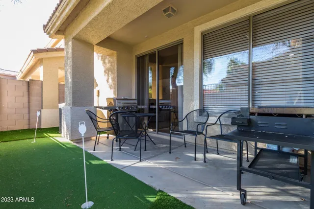 a view of a patio with table and chairs and potted plants
